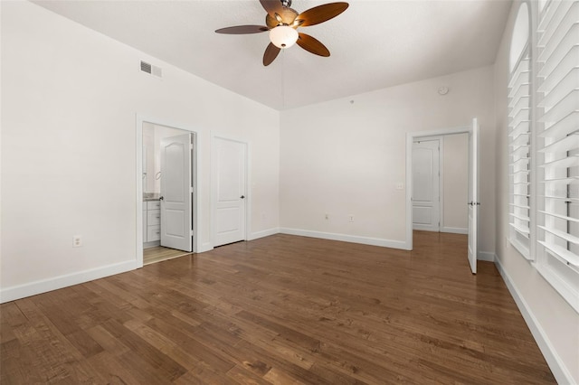 502 Mirasol Cir Unit 103, Kissimmee, FL 34747 - unfurnished bedroom with dark wood-style flooring, ensuite bath, and a ceiling fan