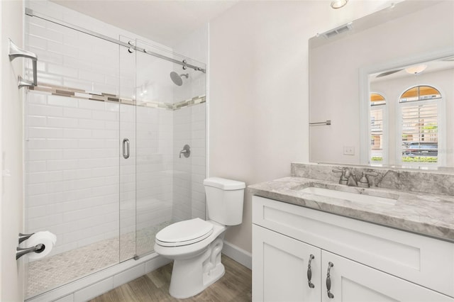 502 Mirasol Cir Unit 103, Kissimmee, FL 34747 - full bathroom featuring a stall shower, vanity, and wood finished floors