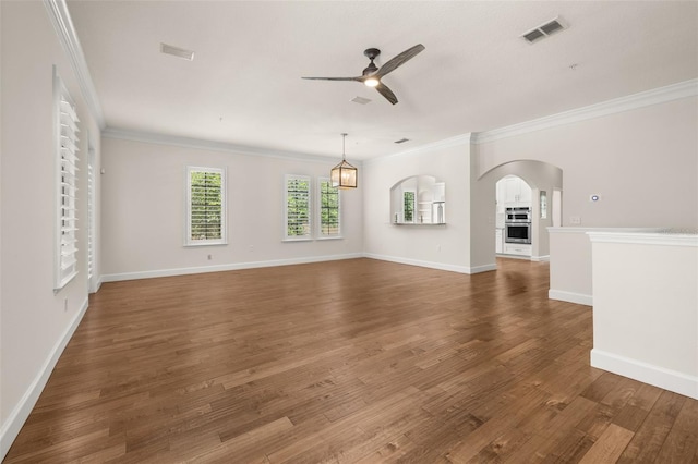 502 Mirasol Cir Unit 103, Kissimmee, FL 34747 - unfurnished living room with a ceiling fan, arched walkways, ornamental molding, and wood finished floors