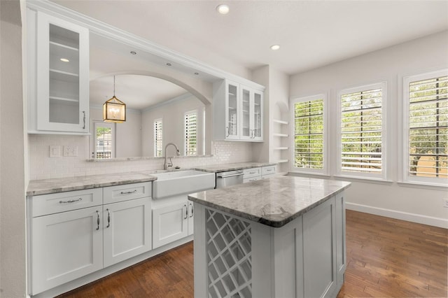 502 Mirasol Cir Unit 103, Kissimmee, FL 34747 - kitchen featuring stainless steel dishwasher, tasteful backsplash, white cabinetry, a center island, and recessed lighting