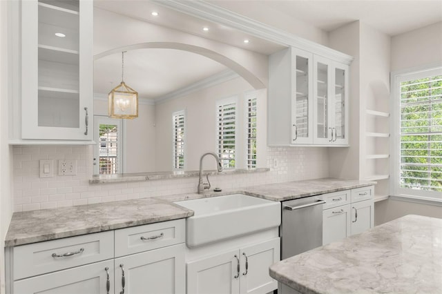 502 Mirasol Cir Unit 103, Kissimmee, FL 34747 - kitchen featuring white cabinetry, decorative backsplash, light stone countertops, ornamental molding, and recessed lighting
