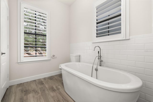 502 Mirasol Cir Unit 103, Kissimmee, FL 34747 - bathroom with a freestanding tub and wood finished floors
