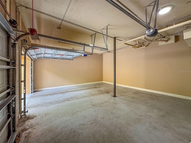 502 Mirasol Cir Unit 103, Kissimmee, FL 34747 - garage featuring a garage door opener and baseboards