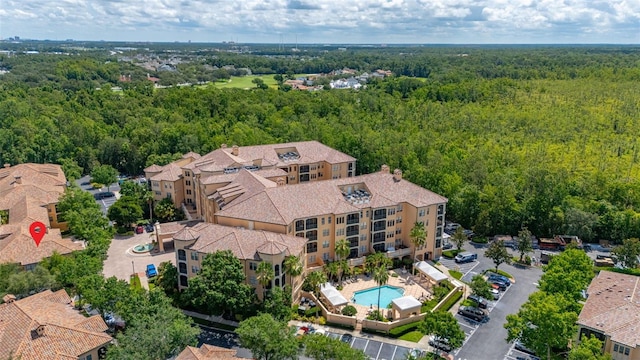 502 Mirasol Cir Unit 103, Kissimmee, FL 34747 - drone / aerial view of a forest and a pool