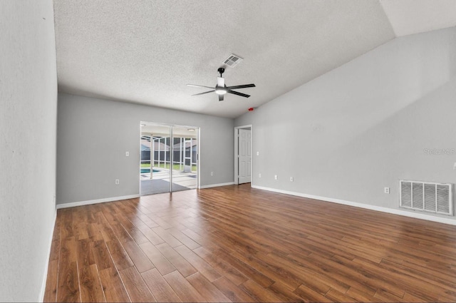 6528 Shepherd Oaks Pass, Lakeland, FL 33811 - spare room featuring vaulted ceiling, ceiling fan, wood finished floors, and a textured ceiling