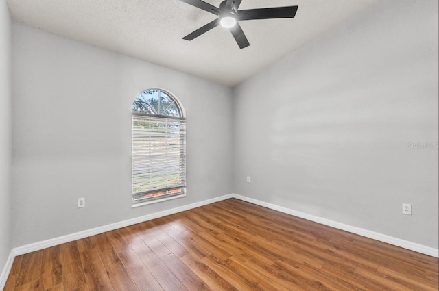 6528 Shepherd Oaks Pass, Lakeland, FL 33811 - empty room with wood finished floors, a ceiling fan, and vaulted ceiling