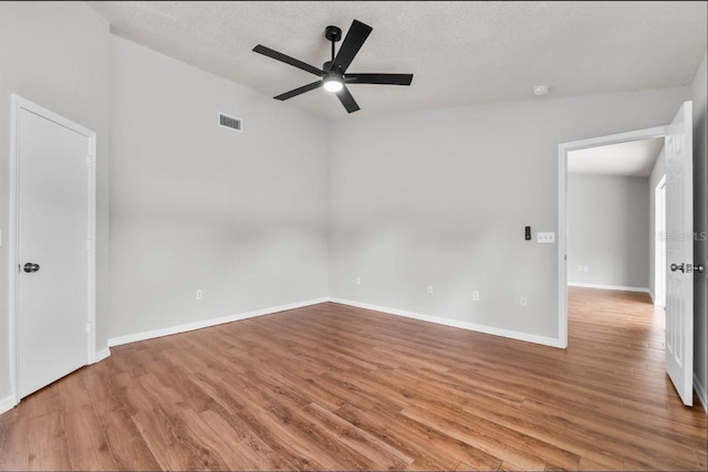 6528 Shepherd Oaks Pass, Lakeland, FL 33811 - unfurnished room with a ceiling fan, wood finished floors, a textured ceiling, and a smoke detector