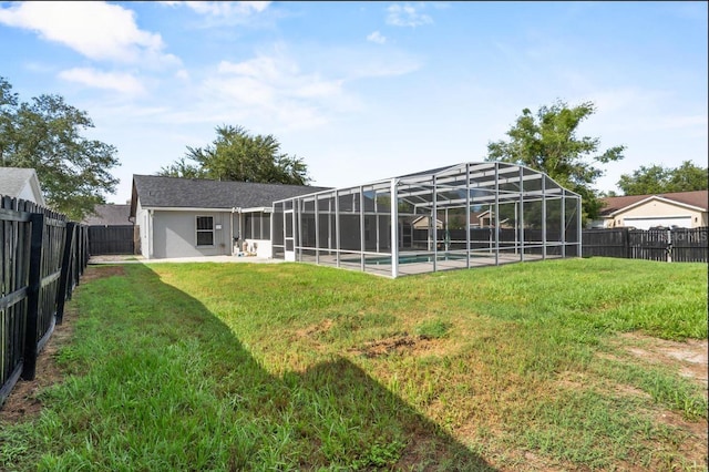 6528 Shepherd Oaks Pass, Lakeland, FL 33811 - back of house with a fenced backyard, glass enclosure, a patio area, and stucco siding