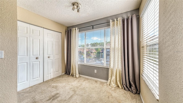 5112 Conroy Rd Unit 24, Orlando, FL 32811 - unfurnished bedroom with a textured wall, carpet, a closet, and a textured ceiling