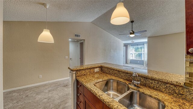 5112 Conroy Rd Unit 24, Orlando, FL 32811 - kitchen featuring a textured ceiling, a textured wall, ceiling fan, pendant lighting, and carpet flooring