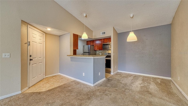5112 Conroy Rd Unit 24, Orlando, FL 32811 - kitchen featuring stainless steel appliances, light colored carpet, a peninsula, hanging light fixtures, and vaulted ceiling