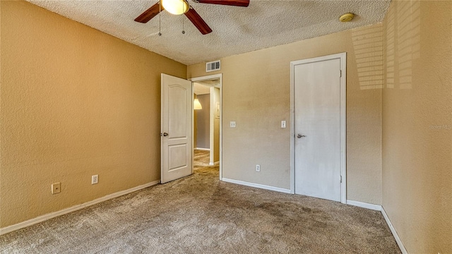 5112 Conroy Rd Unit 24, Orlando, FL 32811 - unfurnished bedroom featuring a textured ceiling, carpet, a textured wall, and a ceiling fan