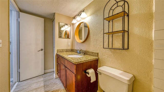 5112 Conroy Rd Unit 24, Orlando, FL 32811 - bathroom with a textured wall, a textured ceiling, and vanity