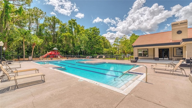 5112 Conroy Rd Unit 24, Orlando, FL 32811 - community pool featuring a patio and view of wooded area