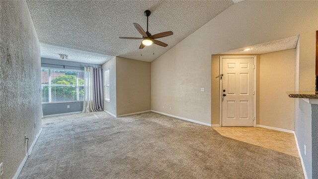 5112 Conroy Rd Unit 24, Orlando, FL 32811 - empty room featuring carpet floors, ceiling fan, vaulted ceiling, and a textured ceiling