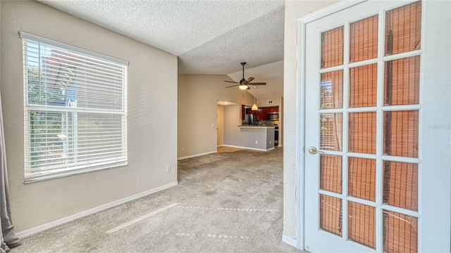 5112 Conroy Rd Unit 24, Orlando, FL 32811 - carpeted empty room featuring a textured ceiling, healthy amount of natural light, a ceiling fan, and lofted ceiling