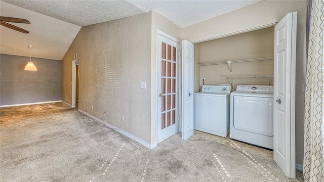 5112 Conroy Rd Unit 24, Orlando, FL 32811 - laundry area featuring washing machine and dryer, carpet flooring, a ceiling fan, a textured ceiling, and a textured wall