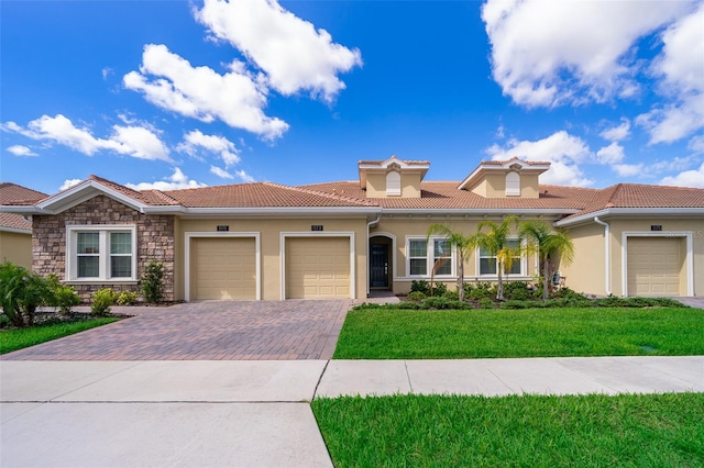 1173 Trappers Trail Loop, Champions Gate, FL 33896 - view of front of home featuring an attached garage, stucco siding, driveway, a front lawn, and a tile roof