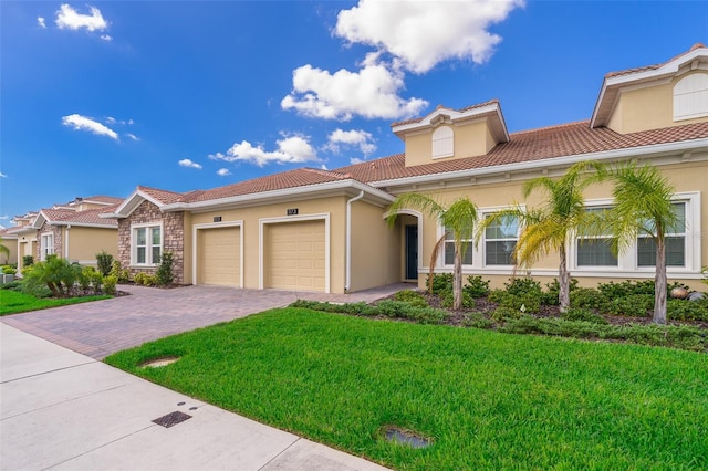 1173 Trappers Trail Loop, Champions Gate, FL 33896 - mediterranean / spanish home with stucco siding, a front yard, and an attached garage