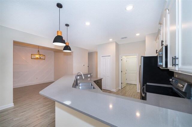1173 Trappers Trail Loop, Champions Gate, FL 33896 - kitchen featuring appliances with stainless steel finishes, white cabinets, light wood finished floors, light countertops, and recessed lighting