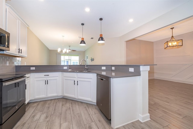 1173 Trappers Trail Loop, Champions Gate, FL 33896 - kitchen featuring stainless steel appliances, a chandelier, light wood-style floors, backsplash, and recessed lighting