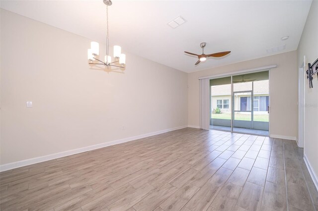 1173 Trappers Trail Loop, Champions Gate, FL 33896 - empty room with light wood finished floors, a chandelier, and ceiling fan