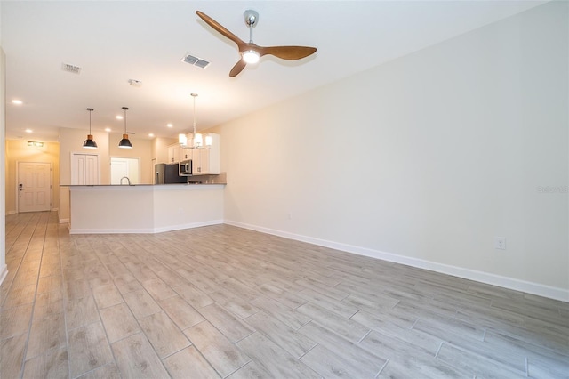 1173 Trappers Trail Loop, Champions Gate, FL 33896 - unfurnished living room featuring light wood finished floors, a ceiling fan, recessed lighting, and a chandelier