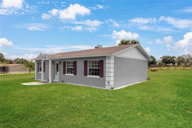 1 Coyer Rd, Haines City, FL 33844 - view of front of house featuring a front lawn and stucco siding