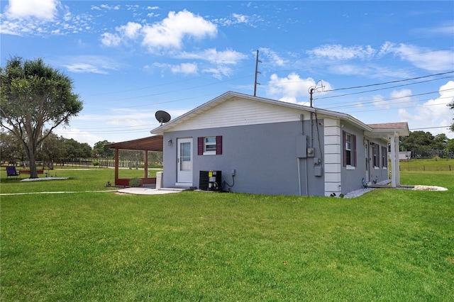 1 Coyer Rd, Haines City, FL 33844 - rear view of property featuring a yard, stucco siding, and a patio area