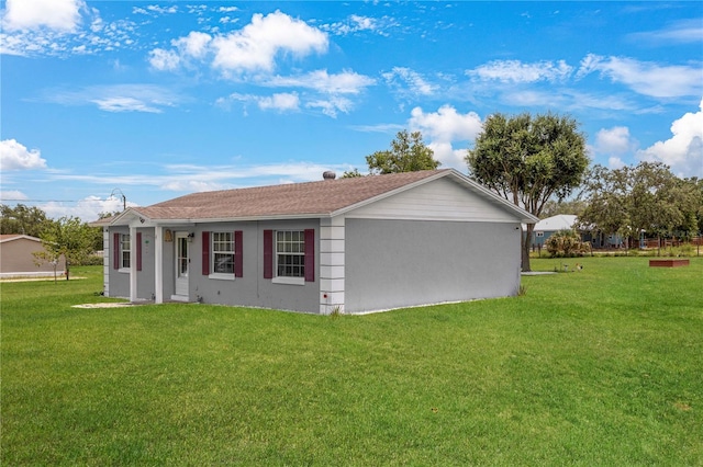 1 Coyer Rd, Haines City, FL 33844 - view of side of property featuring a lawn and stucco siding