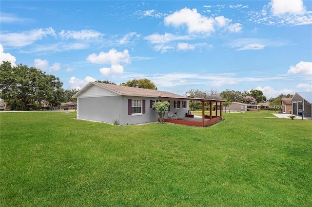 1 Coyer Rd, Haines City, FL 33844 - back of house with a patio area, a lawn, and stucco siding