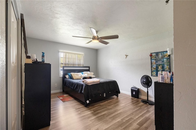 1 Coyer Rd, Haines City, FL 33844 - bedroom featuring wood finished floors, a textured ceiling, and a ceiling fan