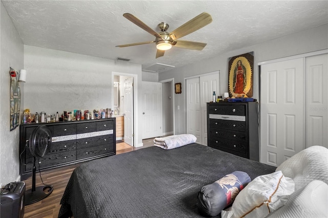 1 Coyer Rd, Haines City, FL 33844 - bedroom with two closets, wood finished floors, ceiling fan, a textured ceiling, and ensuite bathroom