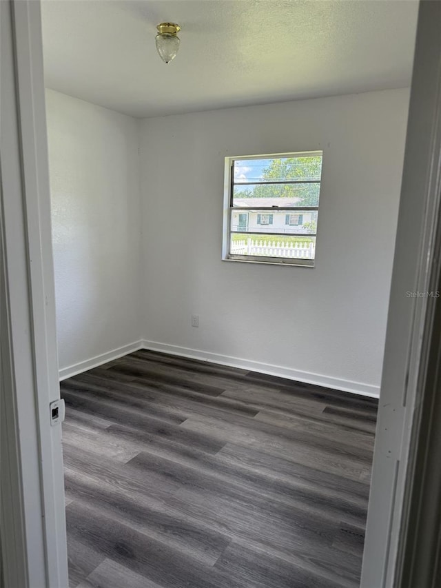 5449 NW 2nd St, Ocala, FL 34482 - unfurnished room featuring dark wood-style floors and baseboards