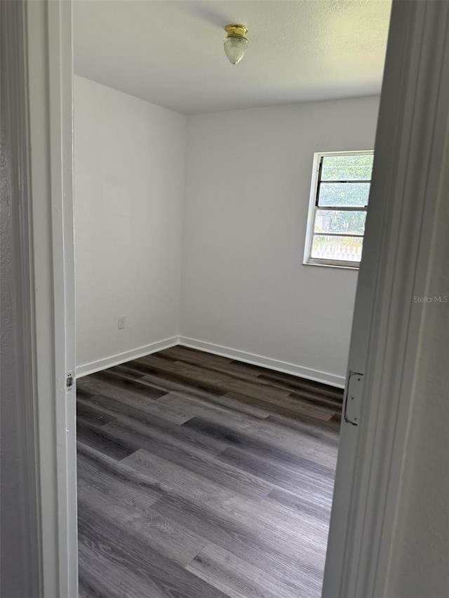 5449 NW 2nd St, Ocala, FL 34482 - spare room with dark wood finished floors and baseboards