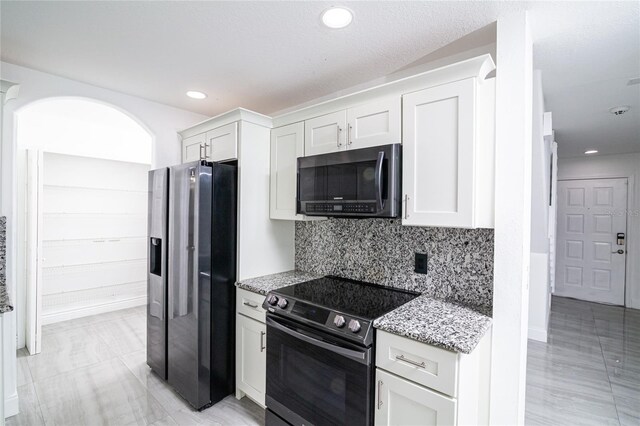 1101 Sandestin Way, Orlando, FL 32824 - kitchen featuring stainless steel appliances, light stone countertops, white cabinets, decorative backsplash, and recessed lighting