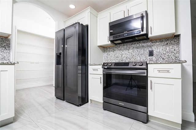 1101 Sandestin Way, Orlando, FL 32824 - kitchen with stainless steel appliances, light stone countertops, white cabinets, backsplash, and recessed lighting