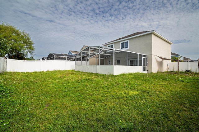 1101 Sandestin Way, Orlando, FL 32824 - rear view of house with stucco siding and glass enclosure