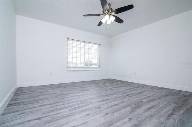 1101 Sandestin Way, Orlando, FL 32824 - spare room featuring wood finished floors, a textured ceiling, and a ceiling fan