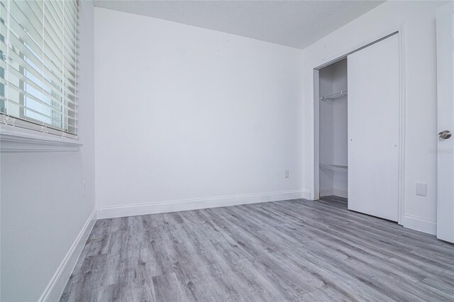 1101 Sandestin Way, Orlando, FL 32824 - unfurnished bedroom featuring wood finished floors and a closet