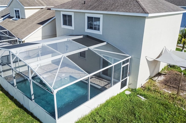 1101 Sandestin Way, Orlando, FL 32824 - view of property exterior with a shingled roof, glass enclosure, stucco siding, and an outdoor pool