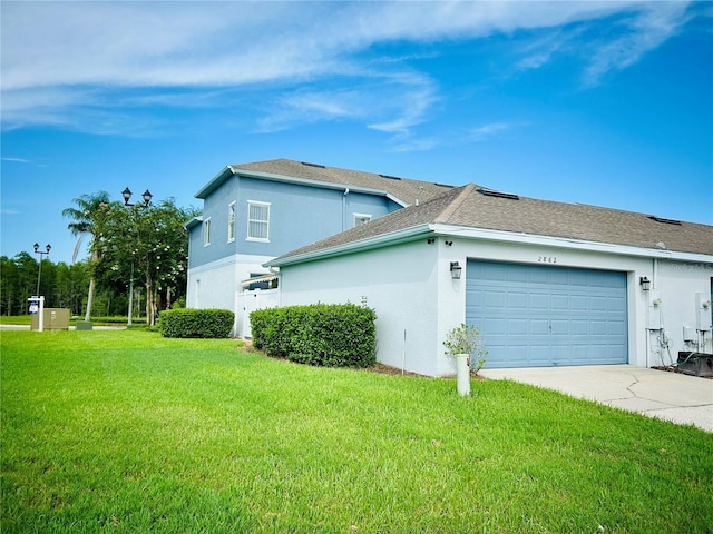 2862 Grasmere View Pkwy, Kissimmee, FL 34746 - view of side of property with stucco siding, concrete driveway, a garage, a yard, and roof with shingles