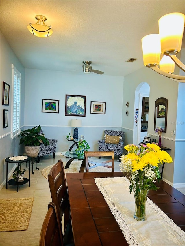 2862 Grasmere View Pkwy, Kissimmee, FL 34746 - dining area featuring arched walkways, a ceiling fan, and wood finished floors