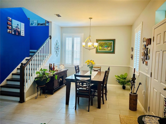 2862 Grasmere View Pkwy, Kissimmee, FL 34746 - dining area featuring a chandelier, plenty of natural light, and stairs