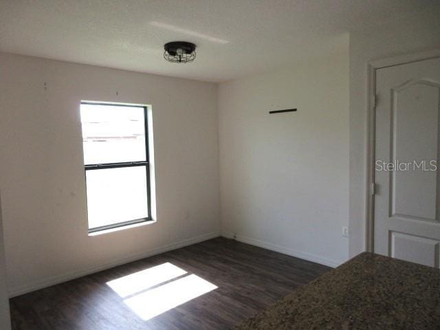 1740 Chatham Green Cir, Ruskin, FL 33570 - spare room with dark wood finished floors and baseboards