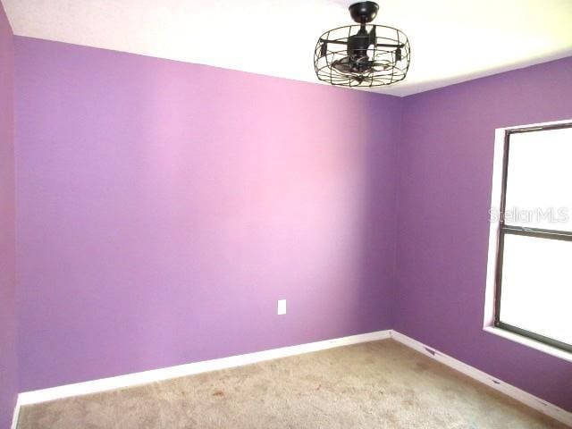 1740 Chatham Green Cir, Ruskin, FL 33570 - empty room featuring light carpet and baseboards
