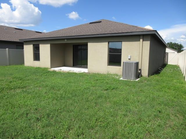 1740 Chatham Green Cir, Ruskin, FL 33570 - back of house featuring stucco siding and a shingled roof