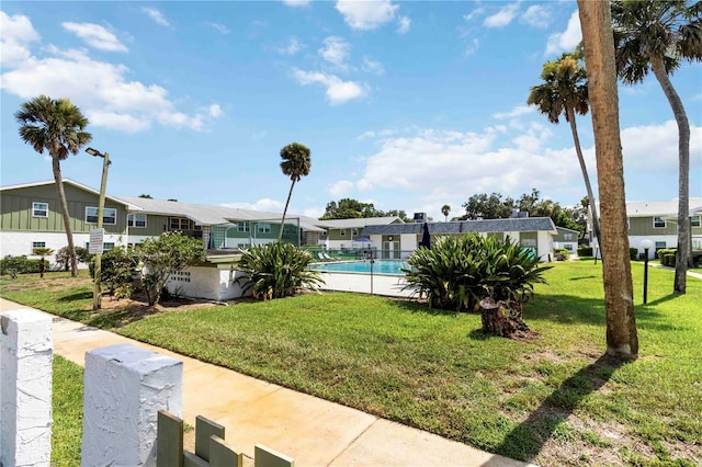 840 Center Ave Unit 80, Daytona Beach, FL 32117 - view of grassy yard featuring a residential view and a community pool