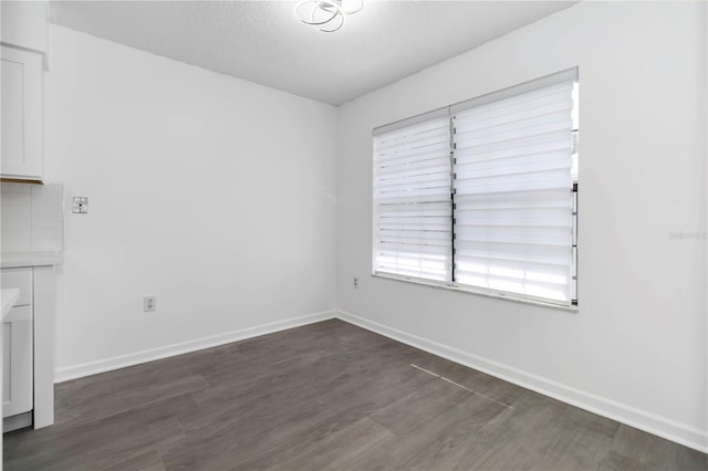 840 Center Ave Unit 80, Daytona Beach, FL 32117 - empty room with dark wood finished floors and a textured ceiling