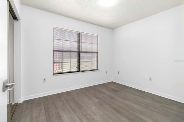 840 Center Ave Unit 80, Daytona Beach, FL 32117 - unfurnished room with dark wood finished floors and a textured ceiling